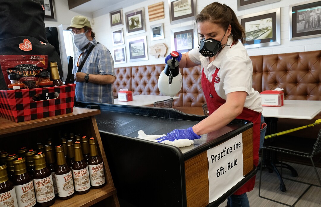 (Francisco Kjolseth  |  The Salt Lake Tribune) Rachael Wilson does one of her regular cleaning runs throughout the store at Snider Brothers Meats in Cottonwood Heights on Tuesday, May 5, 2020, where her parents Will and Amy Wilson, have been requiring that all customers wear masks or facial coverings when they come to shop. They say it's important to protect their employees, several of whom are the sole breadwinners at home and have at-risk family members.