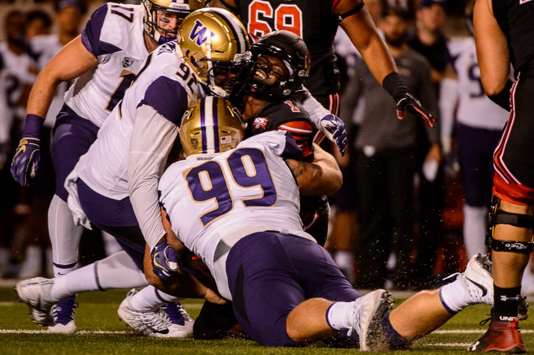 (Trent Nelson | The Salt Lake Tribune)  Utah Utes quarterback Tyler Huntley (1) is tackled as the University of Utah hosts Washington at Rice-Eccles Stadium in Salt Lake City, Saturday Sept. 15, 2018.