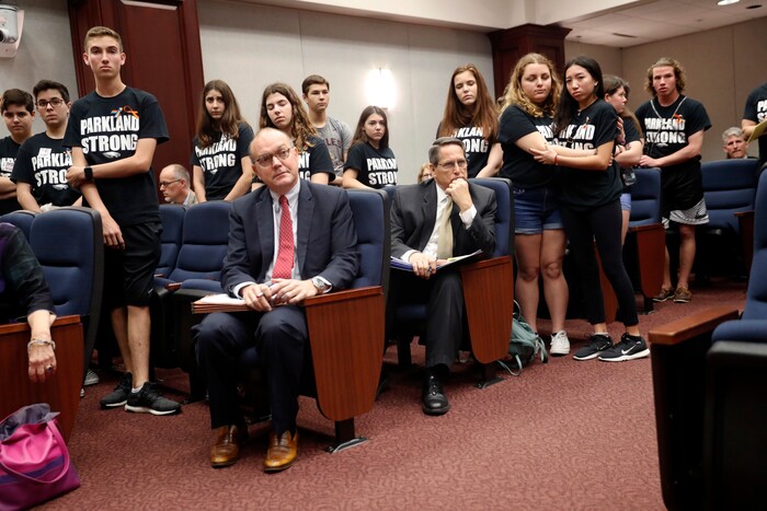 Lobbyists and attorneys listen as student survivors from Marjory Stoneman Douglas High School, where more than a dozen students and faculty were killed in a mass shooting on Wednesday, interrupt a house legislative committee hearing, to challenge lawmakers on gun control reform, in Tallahassee, Fla., Wednesday, Feb. 21, 2018. (AP Photo/Gerald Herbert)