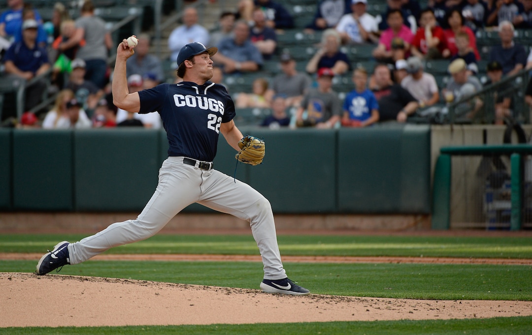 (Francisco Kjolseth  |  The Salt Lake Tribune)  Jarod Lessar stretches out for the pitch as Utah and BYU renew their rivalry on the baseball diamond as they battle it out at Smith's Ballpark in Salt Lake City on Tuesday, May 14, 2019.