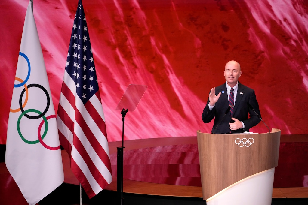 (David Goldman | AP) Utah Gov. Spencer Cox speaks about Salt Lake City's bid to host the 2034 Winter Olympics, during the 142nd IOC session at the 2024 Summer Olympics, Wednesday, July 24, 2024, in Paris. Cox is with a Utah 2034 working group at the Milan-Cortina 2026 Winter Games, where he was asked about President Donald Trump calling an athlete "a real loser."