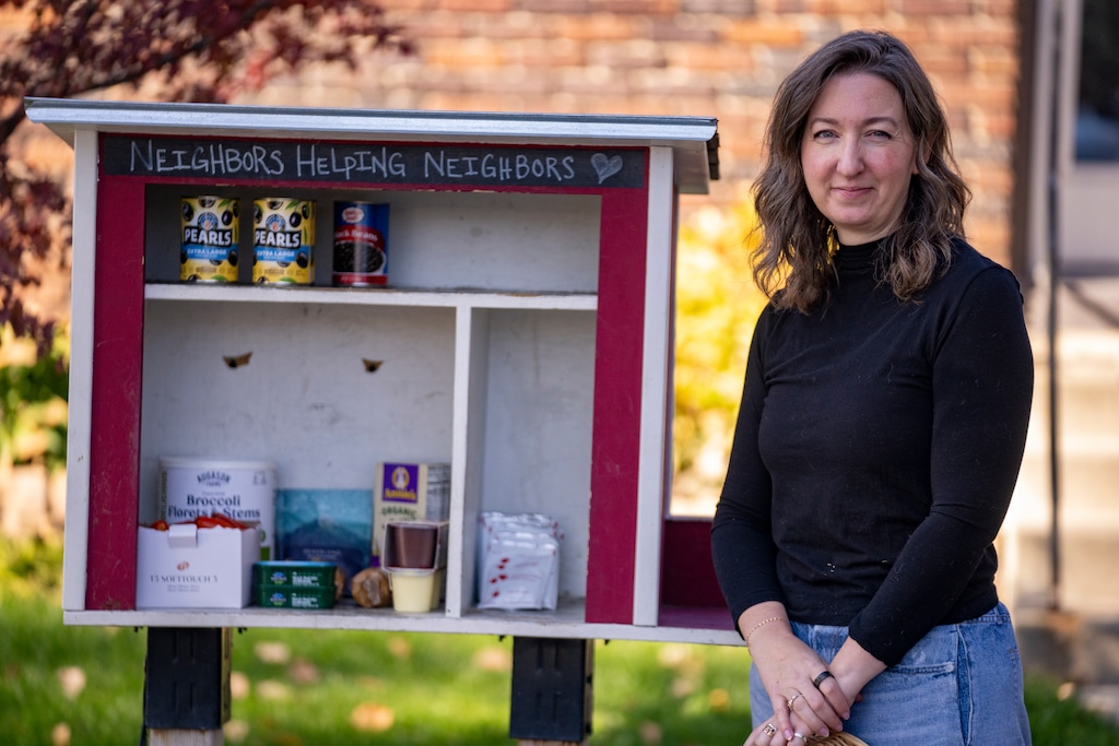 (Rick Egan | The Salt Lake Tribune) Nicole Vallieres stands by her mini pantry near Liberty Park in Salt Lake City, on Friday, Oct. 31, 2025. She estimates they go through "over 50 pounds of food and toiletries every day."

