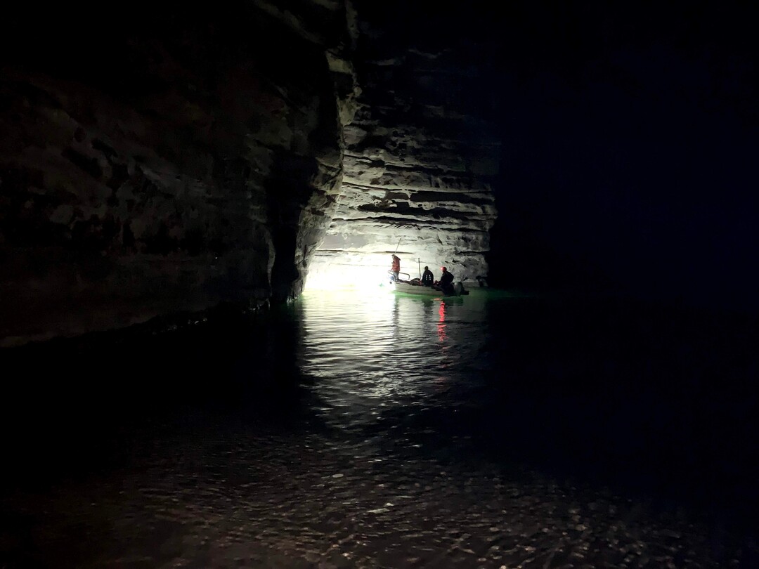 (Judy Fahys  |  InsideClimate News) The U.S. Geological SurveyÕs Grand Canyon Research and Monitoring Center runs three trips each year to keep track of humpback chub and other fish species. Here, Clay Nelson is using a floodlight to find stunned fish and retrieve them at a sampling site on the main Colorado downstream from the Little Colorado River.