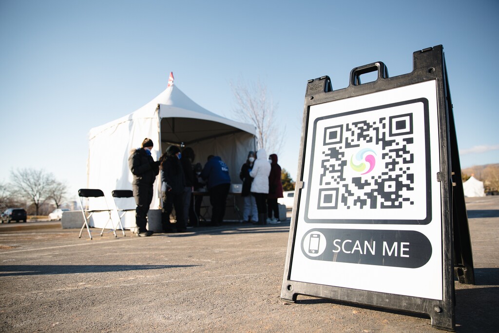 (Rachel Rydalch | The Salt Lake Tribune) Healthcare workers stay warm underneath a tent as they wait for more people to arrive to be tested for coronavirus in Salt Lake City on Thursday, Feb. 3, 2022.