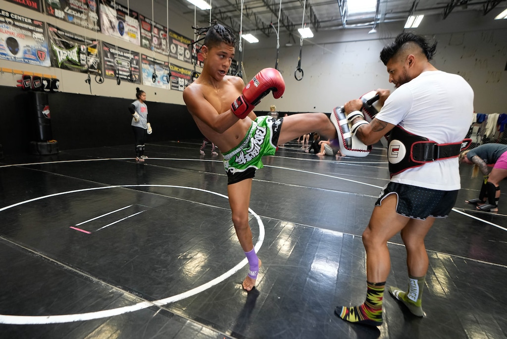 (Francisco Kjolseth | The Salt Lake Tribune) Gavin Garcia, 16, trains with his dad Mario at Elite Performance MMA Gym in Sandy on Saturday, Aug. 13, 2022. Elite Performance mixed martial arts is owned by Jeremy Horn, one of the legendary fighters/trainers in the state.