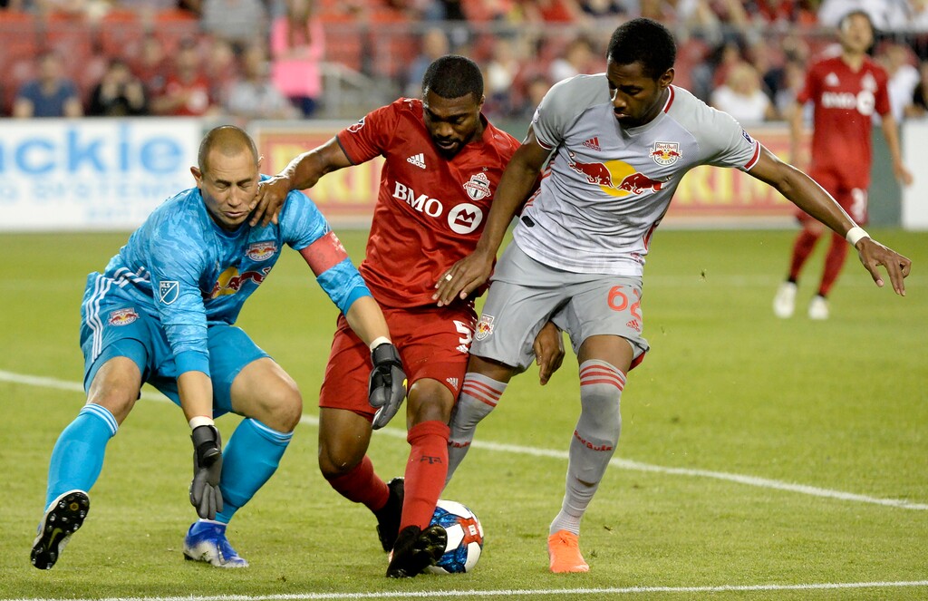 (Nathan Denette | The Canadian Press via AP) New York Red Bulls defender Michael Murillo (62) fails to stop Toronto FC defender Ashtone Morgan (5) from taking the ball away from Red Bulls goalkeeper Luis Robles (31) during the second half of an MLS soccer match Wednesday, July 17, 2019, in Toronto. Morgan went on to score.