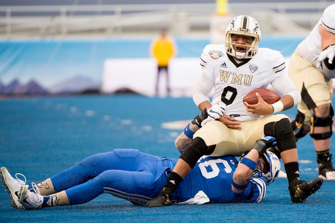 (Jeremy Harmon  |  The Salt Lake Tribune) Western Michigan Broncos quarterback Kaleb Eleby (9) sits on Brigham Young Cougars linebacker Sione Takitaki (16) after getting sacked by him as BYU faces the Western Michigan Broncos in the Famous Idaho Potato Bowl in Boise, Idaho, on Friday, Dec. 21, 2018.