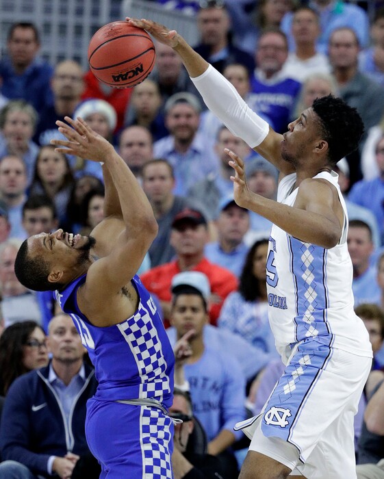 North Carolina's Tony Bradley, right, blocks Kentucky's Isaiah Briscoe during the first half of an NCAA college basketball game Saturday, Dec. 17, 2016, in Las Vegas. (AP Photo/John Locher)