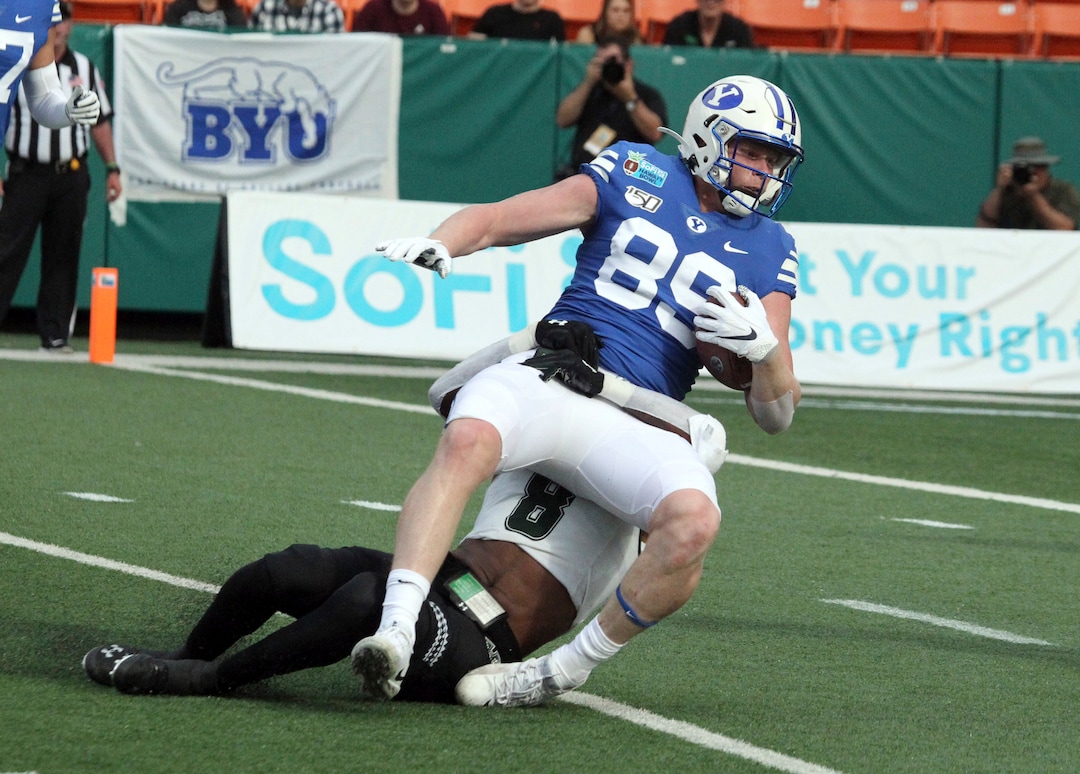 December 24, 2019 - Brigham Young Cougars tight end Matt Bushman (89) gets tacken down by Hawaii Rainbow Warriors defensive back Eugene Ford (8) after a long pass play during a game at the SoFi Hawaii Bowl between the Brigham Young Cougars and the Hawaii Rainbow Warriors at the Stan Sheriff Center in Honolulu, HI - Michael Sullivan/CSM.(Credit Image: &copy; Michael Sullivan/CSM via ZUMA Wire) (Cal Sport Media via AP Images)