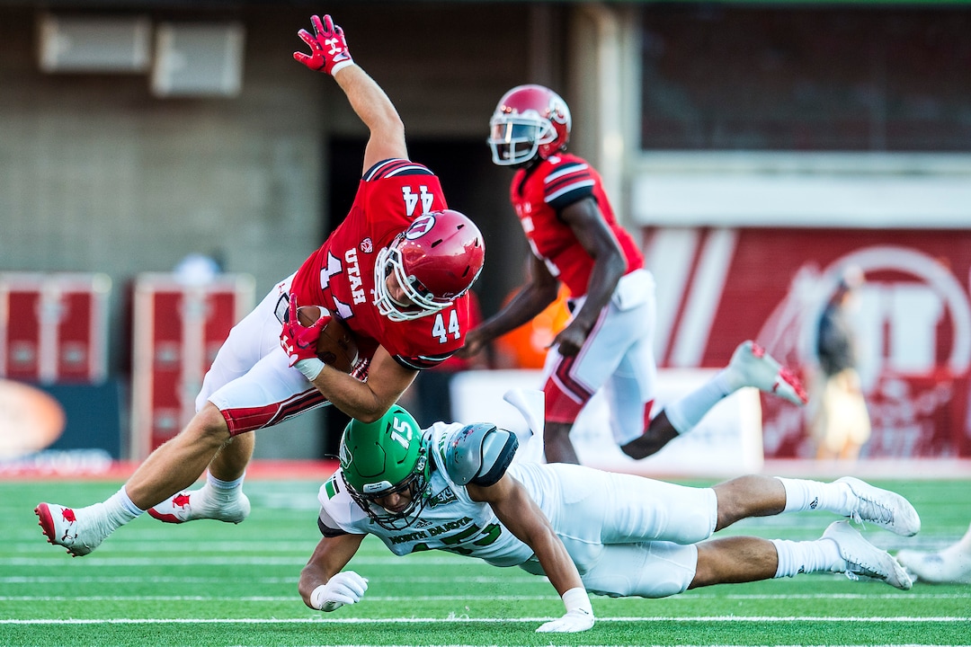 (Chris Detrick  |  The Salt Lake Tribune)  North Dakota Fighting Hawks linebacker Jaxson Turner (15) tackles Utah Utes linebacker Jake Jackson (44) during the game at Rice-Eccles Stadium Thursday, August 31, 2017. Utah Utes are leading North Dakota Fighting Hawks 17-9 at halftime. 