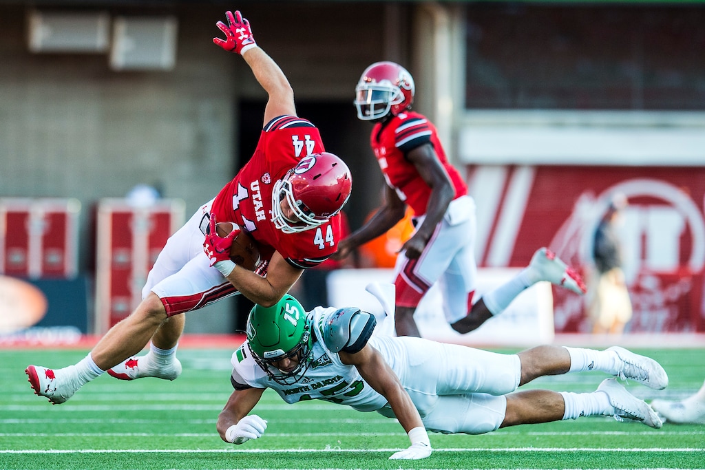 (Chris Detrick | The Salt Lake Tribune) North Dakota Fighting Hawks linebacker Jaxson Turner (15) tackles Utah Utes linebacker Jake Jackson (44) during the game at Rice-Eccles Stadium Thursday, August 31, 2017. Utah Utes are leading North Dakota Fighting Hawks 17-9 at halftime.