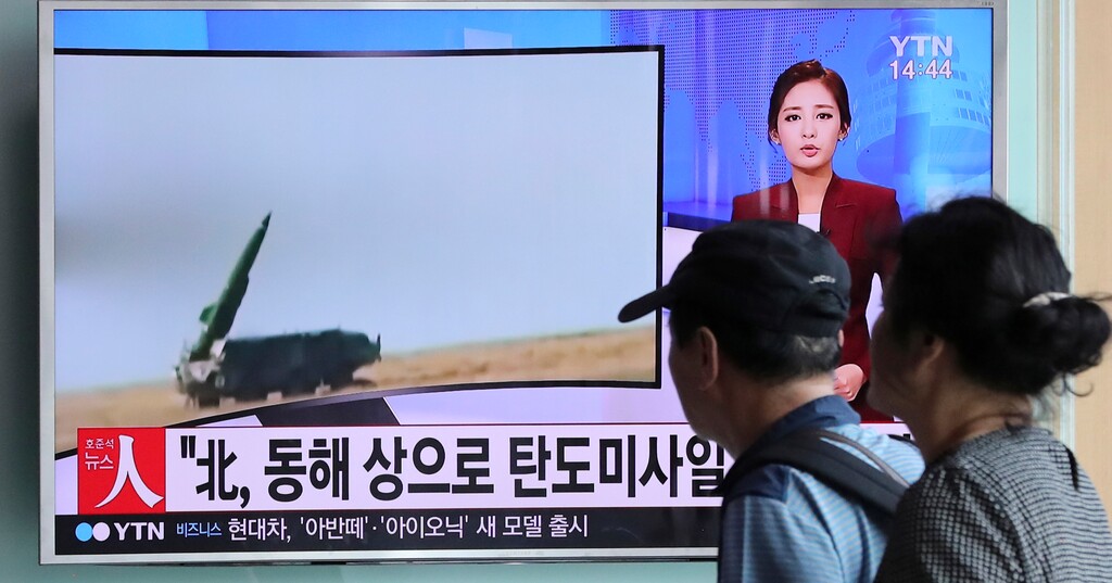 People watch a TV news program reporting about North Korea's missile launch, at the Seoul Train Station in Seoul, South Korea, Monday, Sept. 5, 2016. North Korea fired three ballistic missiles off its east coast Monday, South Korea's military said, in a show of force timed to the G-20 economic summit in China. The letters on the screen read: "North Korea, ballistic missiles to east coast." (AP Photo/Lee Jin-man)