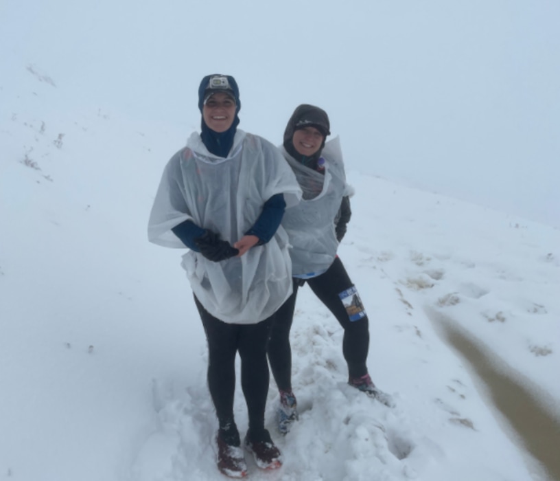 (Courtesy Stephanie Coleman) Runners Stephanie Coleman, left, and Katie Wilkins pose for a photo in the snow at the top of Francis Peak during an ultramarathon on Saturday, Oct. 9, 2021.