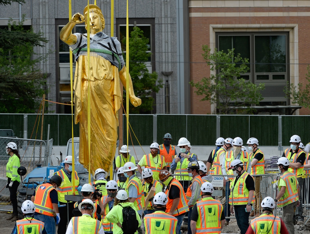 (Francisco Kjolseth  |  The Salt Lake Tribune) Crews get a closer look of the Angel Moroni statue after it was pulled from atop the Salt Lake Temple on Monday, May 18, 2020. The temple closed in December for seismic upgrades and sustained minor damager during the March 18, 2020, magnitude 5.7 earthquake when the trumpet held by the angel fell off and several smaller spire stones were displaced. Fewer and fewer temples of The Church of Jesus Christ of Latter-day Saints are being built without the iconic Moroni statues. This one, however, will be returned to the top of the Salt Lake Temple.
