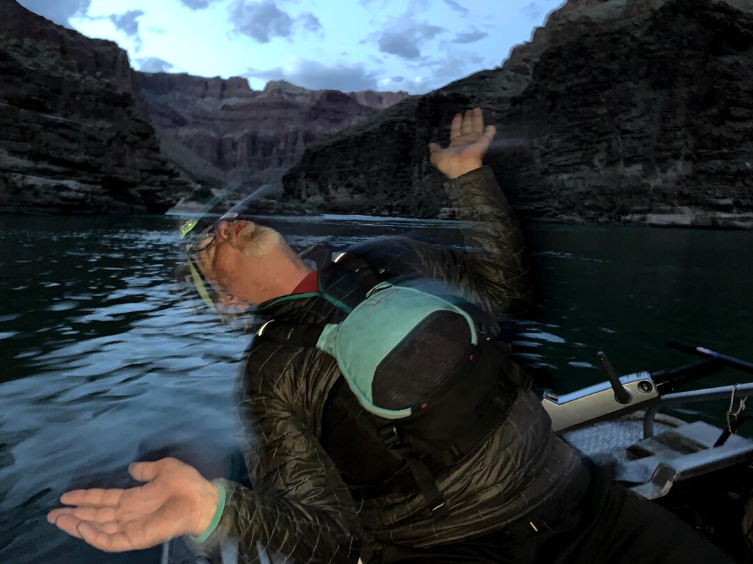 (Judy Fahys  |  InsideClimate News) Dennis Harris, part of the research team monitoring juvenile humpback chub last spring in Grand Canyon National Park, imitates how native fish respond to electrofishing, a non-lethal capture technique. The scientific teams stun fish with electricity so they can be counted, measured and tagged in an experience likened to Òalien abductionÓ for the fish.