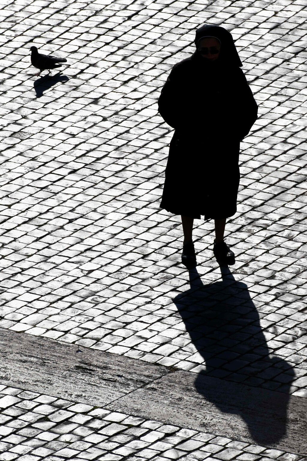 (AP Photo/Pier Paolo Cito, File) In this Sunday, Dec. 20, 2009, photo, a nun is silhouetted in St. Peter's Square at the Vatican. Some nuns are now finding their voices, buoyed by the #MeToo movement and the growing recognition that adults can be victims of sexual abuse when there is an imbalance of power in a relationship. The sisters are going public in part because of years of inaction by church leaders, even after major studies on the problem in Africa were reported to the Vatican in the 1990s.