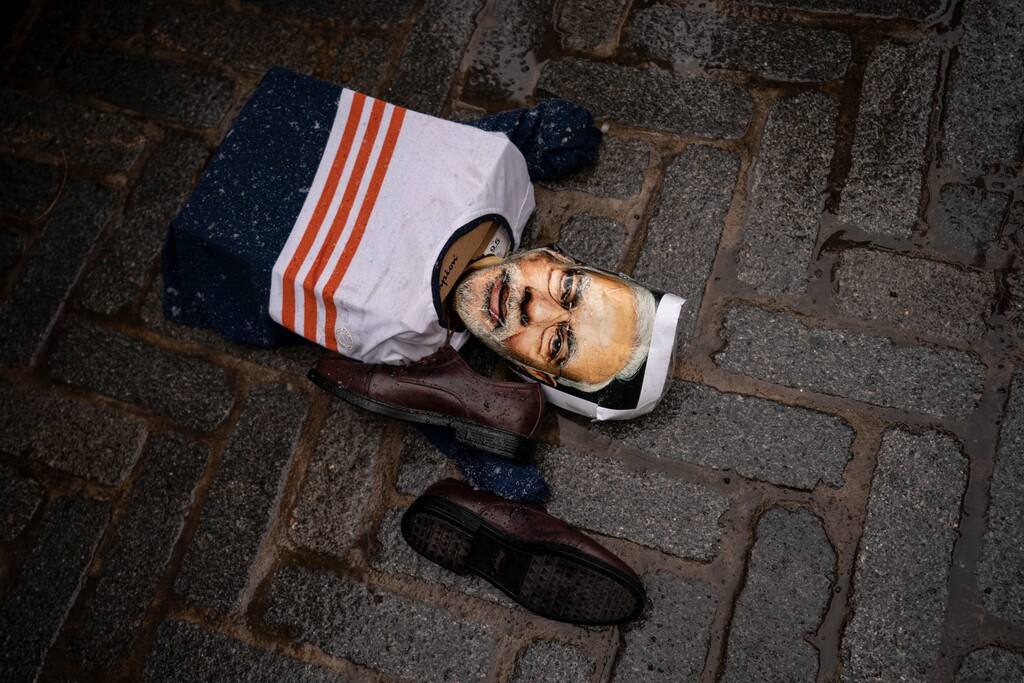 An effigy of Narendra Modi, prime minister of India, lies on the ground as protesters gather outside the Consulate General of India, Tuesday, Jan. 26, 2021, in the Manhattan borough of New York. (AP Photo/John Minchillo)