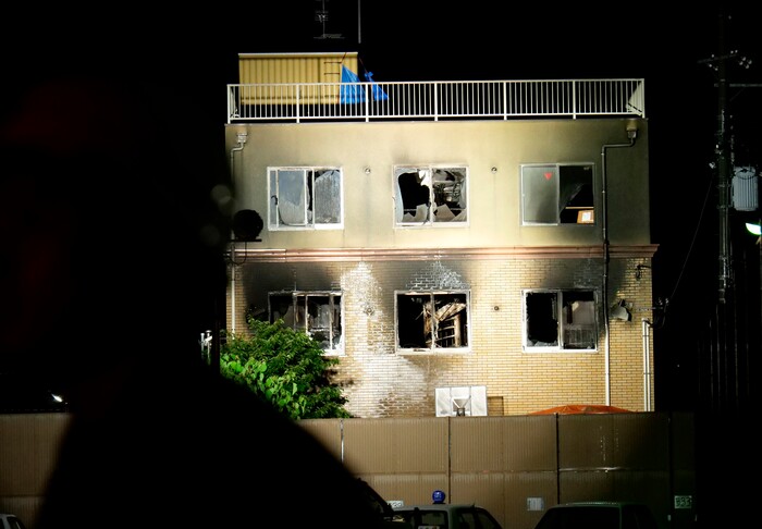 (Hiromi Tanoue | AP Photo) Light is cast on the building of Kyoto Animation following a fire in Kyoto, western Japan, Thursday, July 18, 2019. The fire broke out in the three-story building in Japan's ancient capital of Kyoto, after a suspect sprayed an unidentified liquid to accelerate the blaze, Kyoto prefectural police and fire department officials said.