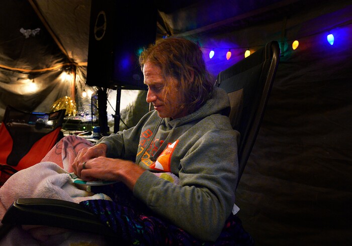 (Scott Sommerdorf | The Salt Lake Tribune)
Matt Van Horn, the winner of the Salt Flats 100 Endurance Run wakes up to eat a small meal in Aid Station 14, Saturday, May 5, 2018. Van Horn finished the race at around 1 a.m., and was so full of energy, he immediately sang a round of karaoke with volunteers at the checkpoint.

