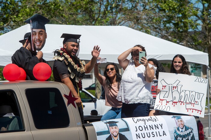 (Rick Egan  |  The Salt Lake Tribune)     Alta Hugh Senior, Johnny Nuusila, waves the the crowd as he rides with his family in the parade of 2020 graduates in a “drive through” graduation ceremony at Alta High, Thursday, May 28, 2020.
