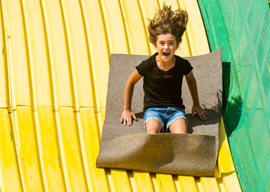 (Rick Egan  |  The Salt Lake Tribune)  Tayah Richens 7, from Lapoint, Utah, goes down the Big Yellow Slide at the Utah State Fair, Sunday, Sept. 8, 2019.