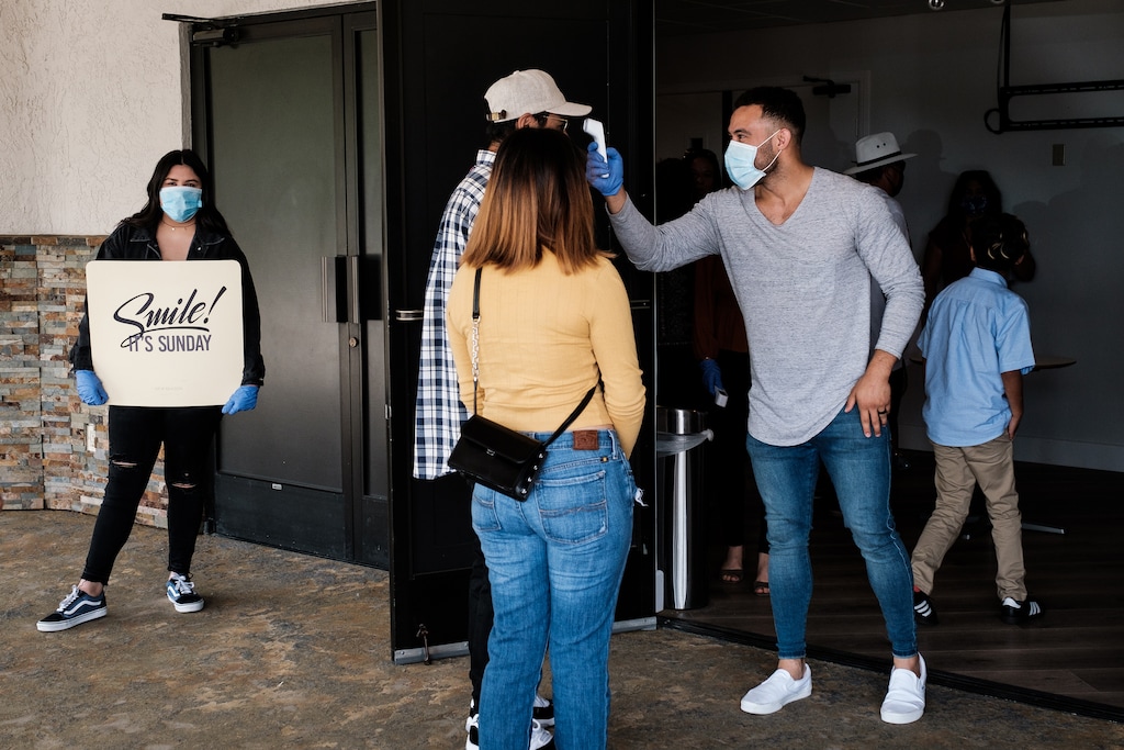 (Max Whittaker | The New York Times) Temperatures are taken before entering the New Season church in Sacramento, Calif., May 31, 2020. More than half of the states have continued to allow religious gatherings, but many churches, synagogues and mosques, for safetyÕs sake, have chosen for months to make do with Zoom sermons and livestreams, but many stuck to remote services on Sunday, but a significant number returned to public worship driven by a combination of pain, prayer and political expression.