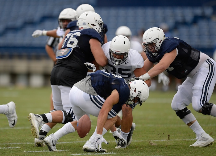 (Francisco Kjolseth  |  The Salt Lake Tribune)  Austin Kafentzis fumbles the ball as BYU holds a scrimmage at LaVell Edwards Stadium in Provo on Thursday, Aug. 10, 2017.