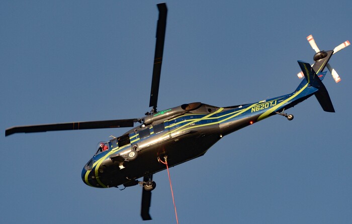 (Francisco Kjolseth  |  The Salt Lake Tribune) A helicopter pilot looks out their protruding bubble to pinpoint a water drop as fire crews battle a fire near Millcreek Canyon, on Saturday, July 11, 2020, started near 3400 South Crestwood Dr., as helicopters, single engine air tankers and multiple crews respond. 