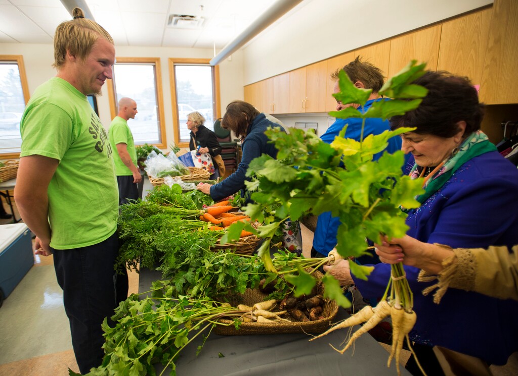Steve Griffin / The Salt Lake Tribune
Salt Lake County Jail inmate Alex Harward smiles as senior citizens at the Liberty Active Aging Center shop for vegetables at the Salt Lake County Jail Horticulture Program's modified farmers market in Salt Lake City, Monday Oct. 24, 2016. The Jail Horticulture Program has been donating its harvest to every active aging center at least once throughout the season. This year's harvest has been so bountiful they are making another round of visits. The Salt Lake County Jail Horticulture Program collaborates with the Salt Lake County Active Aging Center, Green Urban Lunchbox and USU Extension Program for the event. The jail's garden is on about 2 acres behind the jail on 900 West and 3300 South.