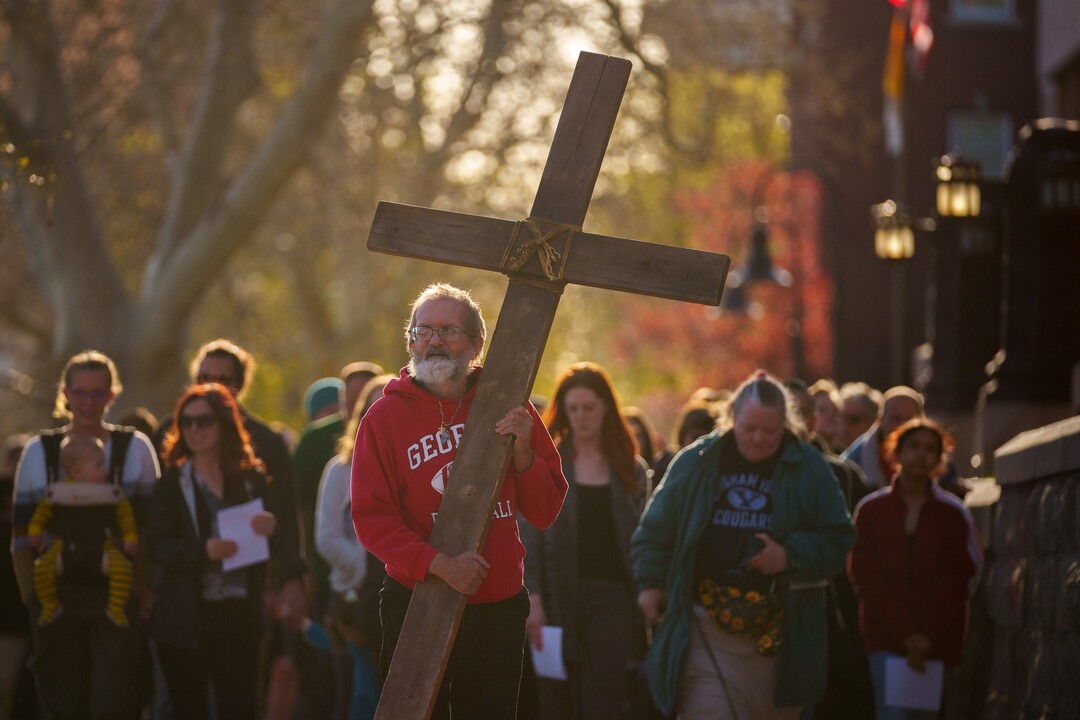(Trent Nelson  |  The Salt Lake Tribune) Alex Bury carries the cross as a Good Friday procession begins at the Cathedral of the Madeleine in Salt Lake City on Friday, April 15, 2022.