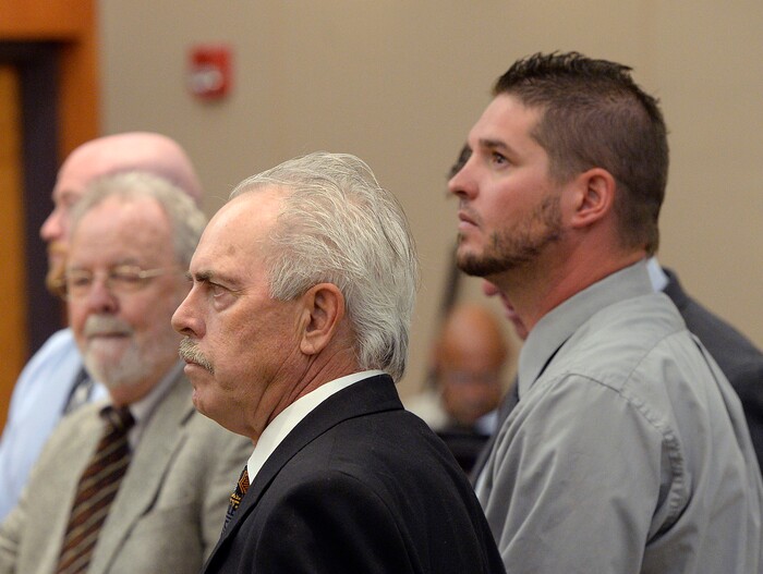 (Al Hartmann | Tribune file photo) Former Daggett County Sheriff Jerry Jorgensen, front left, talks with lawyers and former jail commander Lt. Benjamin Lail, right, in Third District Court in Park City on July 17, 2017 before Judge Kent Holmberg on charges connected to the abuse of jail inmates at the Daggett County jail. A third person charged at far left is Deputy Joshua Cox.