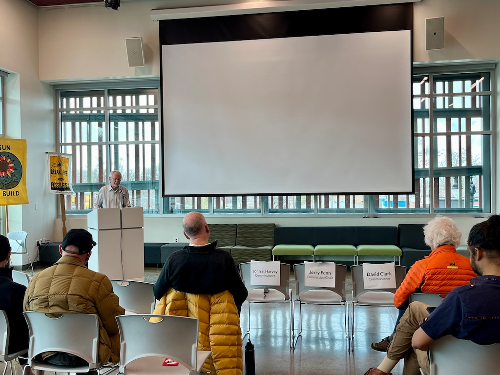 (Shannon Sollitt | The Salt Lake Tribune) Stan Holmes, outreach coordinator for UCARE, addresses Rocky Mountain Power customers about the utility's proposed rate hike. A row of chairs reserved for the Public Service Commission and PacifiCorps executives was empty.
