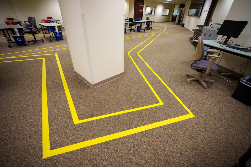 (Trent Nelson  |  The Salt Lake Tribune) Yellow tape marks a path where ballot observers can stand at Salt Lake County's ballot-processing center in Salt Lake City on Friday, Oct. 21, 2022.