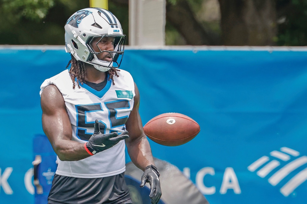 Carolina Panthers linebacker Devin Lloyd tosses a ball during a drill at the team's NFL football practice in Charlotte, N.C., Tuesday, June 9, 2026. (AP Photo/Nell Redmond)