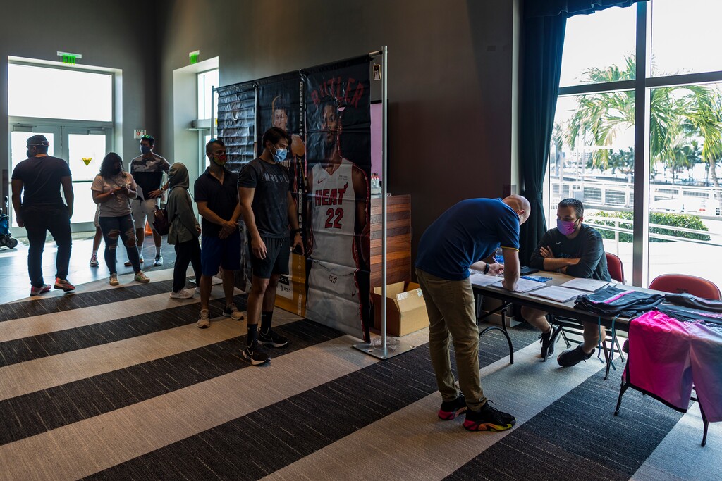 (Saul Martinez | The New York Times) People register at a COVID-19 vaccination event in Miami on Aug. 5, 2021. The Food and Drug Administration’s independent panel of vaccine advisers is meeting Friday, Sept. 17, 2021, to discuss the case for booster shots of the Pfizer-BioNTech coronavirus vaccine, and to vote on whether the agency should approve additional doses for people 16 and older.