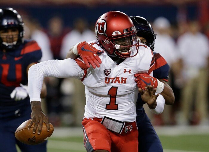 Arizona linebacker Tony Fields II tackles Utah quarterback Tyler Huntley (1) during the first half during an NCAA college football game, Friday, Sept. 22, 2017, in Tucson, Ariz. Huntley left the game with an injury. (AP Photo/Rick Scuteri)