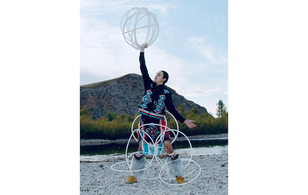 (Alvarado Tsosie & Hakes law firm) Pictured is Jerrhan First Charger, an Indigenous student at Brigham Young University, who has fought to continue wearing his traditional long braids after the school instructed that he'd need to cut his hair to abide by its dress and grooming standards.