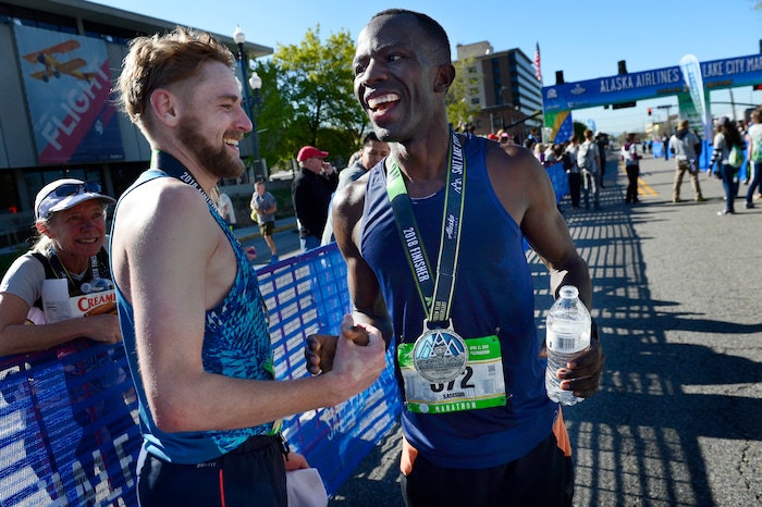 (Scott Sommerdorf | The Salt Lake Tribune)Second place finisher, Daniel Bishop of Salt Lake City, left, greets third place finisher Samson Mutua of Colorado Springs, CO, who posted a time of 2:31:52.62 in the Salt Lake City marathon, Saturday, April 21, 2018.