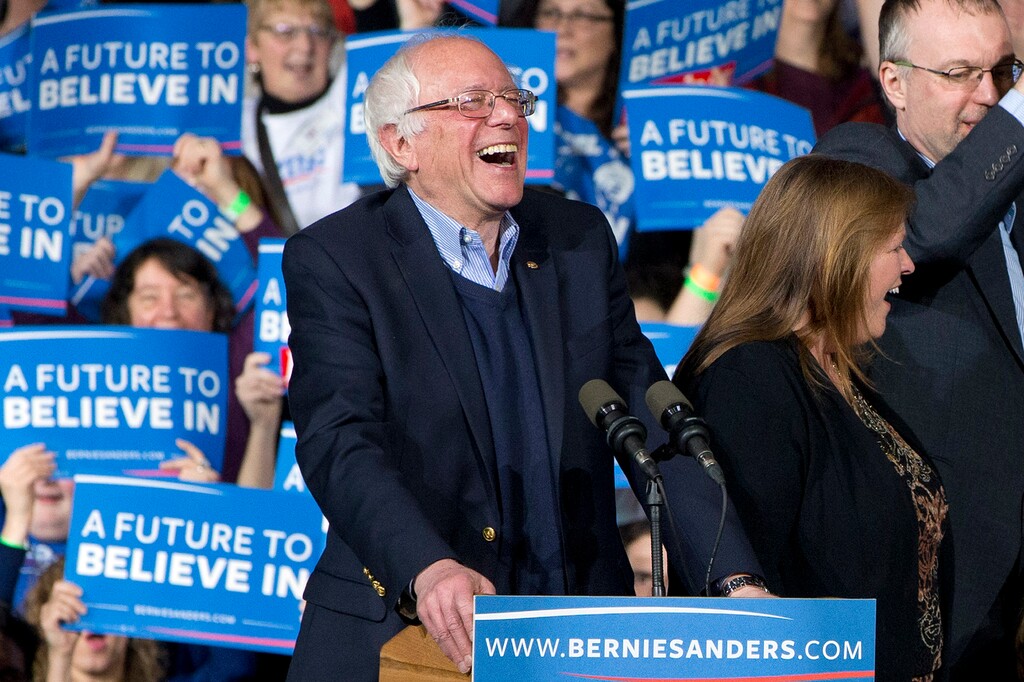 Democratic presidential candidate Sen. Bernie Sanders, I-Vt., laughs as he arrives with his wife Jane Sanders, and his son Levi Sanders to a primary night rally in Essex Junction, Vt., Tuesday, March 1, 2016, on Super Tuesday. (AP Photo/Jacquelyn Martin)