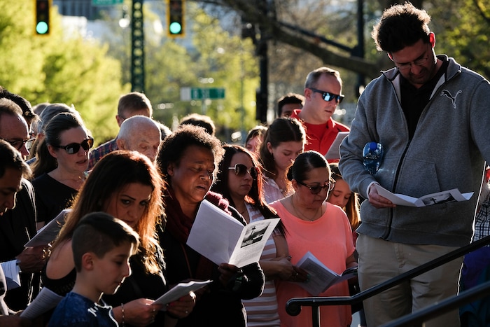 (Francisco Kjolseth  |  The Salt Lake Tribune)  Christians sing hymnals before marching through streets of Salt Lake City on Good Friday to symbolically mark Jesus' carrying the cross to his crucifixion beginning at Cathedral of the Madeleine.