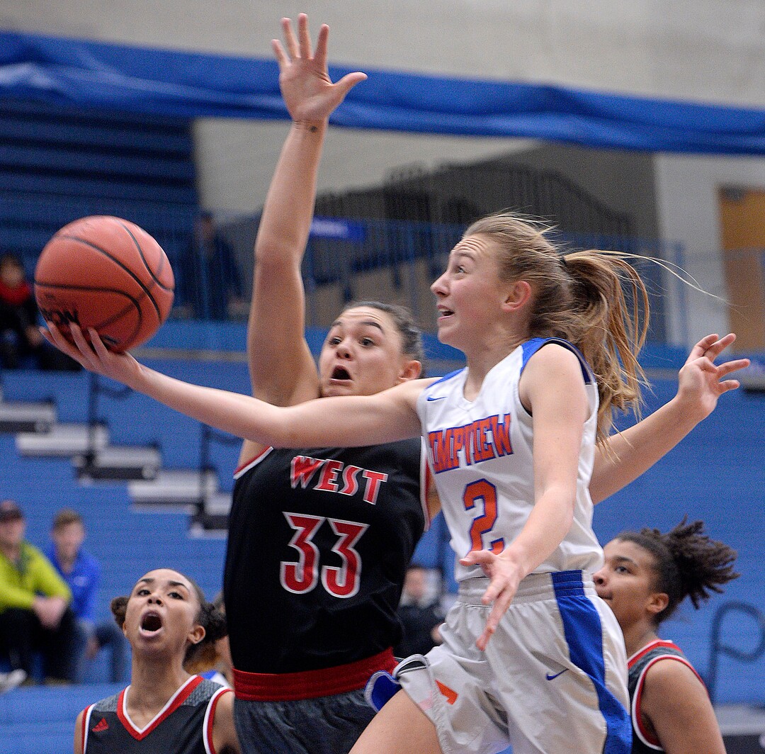 (Al Hartmann  |  The Salt Lake Tribune) 	Timpview's Madelyn Boulton drives to the hoop as West's Brianna White, left, defends in the Class 5 girls' basketball playoff game Monday Feb. 19 2018