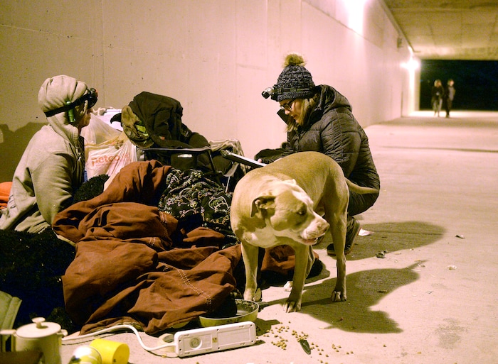 (Al Hartmann | The Salt Lake Tribune) Charly Swett, with Volunteers of America, right, interviews Thumper for the annual Point In Time count of homeless people in Salt Lake City at 4:30 a.m. Thursday, Jan. 25, 2018. Thumper has been homeless off and on for 25 years, and spent the night with a couple friends camped in the tunnel between Sugar House Park and Hidden Hollow. Hank a friend's dog in foreground.
