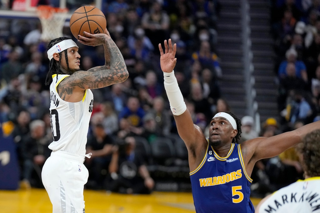 Utah Jazz guard Jordan Clarkson, left, makes a 3-point basket while being defended by Golden State Warriors forward Kevon Looney (5) during the second half of an NBA basketball game in San Francisco, Wednesday, Dec. 28, 2022. (AP Photo/Jeff Chiu)