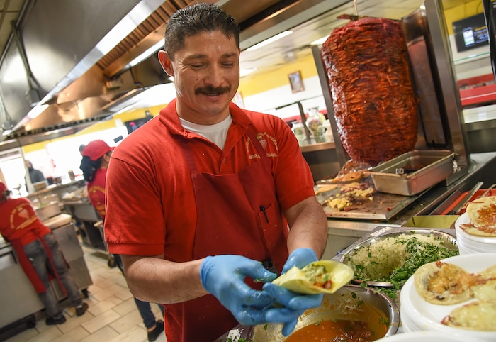 (Francisco Kjolseth  |  The Salt Lake Tribune)  Raul Aispuro assembles tacos al pastor, the most popular offering at Tacos Mi Caramelo, a late-night taqueria that is open until 2 a.m. most nights and 24-hours a day on Friday and Saturday in West Valley City.