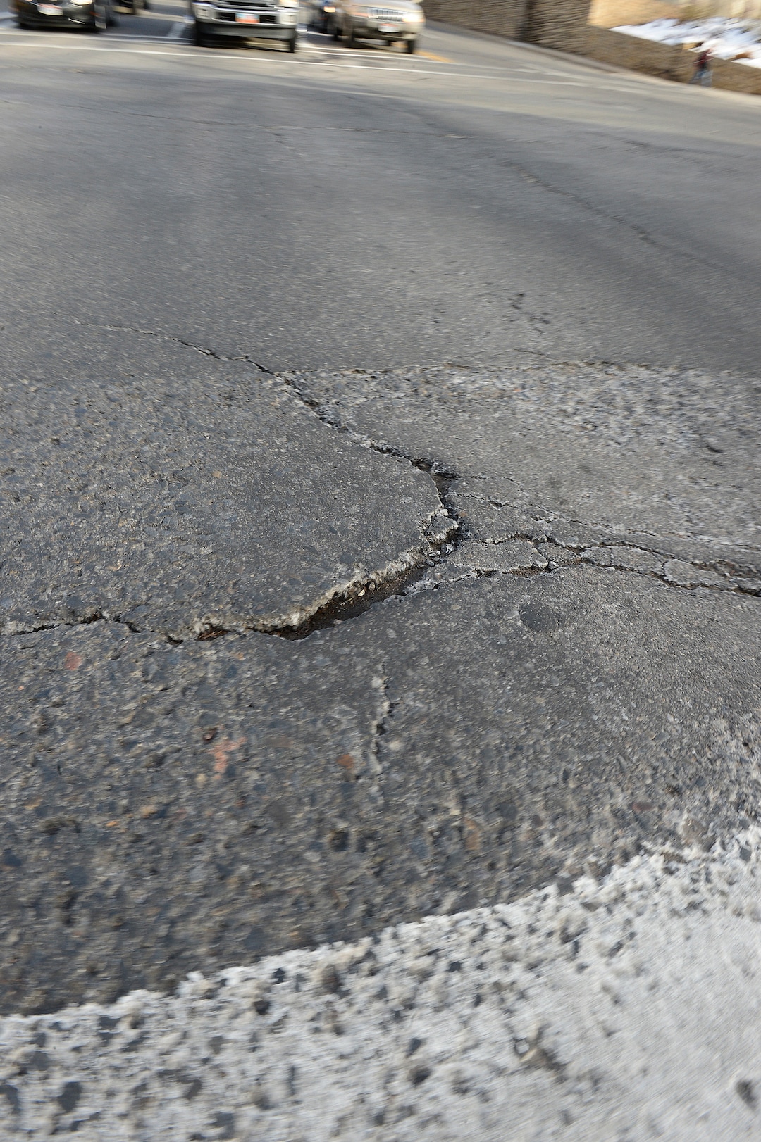 (Scott Sommerdorf   |  The Salt Lake Tribune)   
A section of the damaged road showing a chunk missing in the intersection of 100 South and University in Salt Lake City, Wednesday, January 24, 2018.