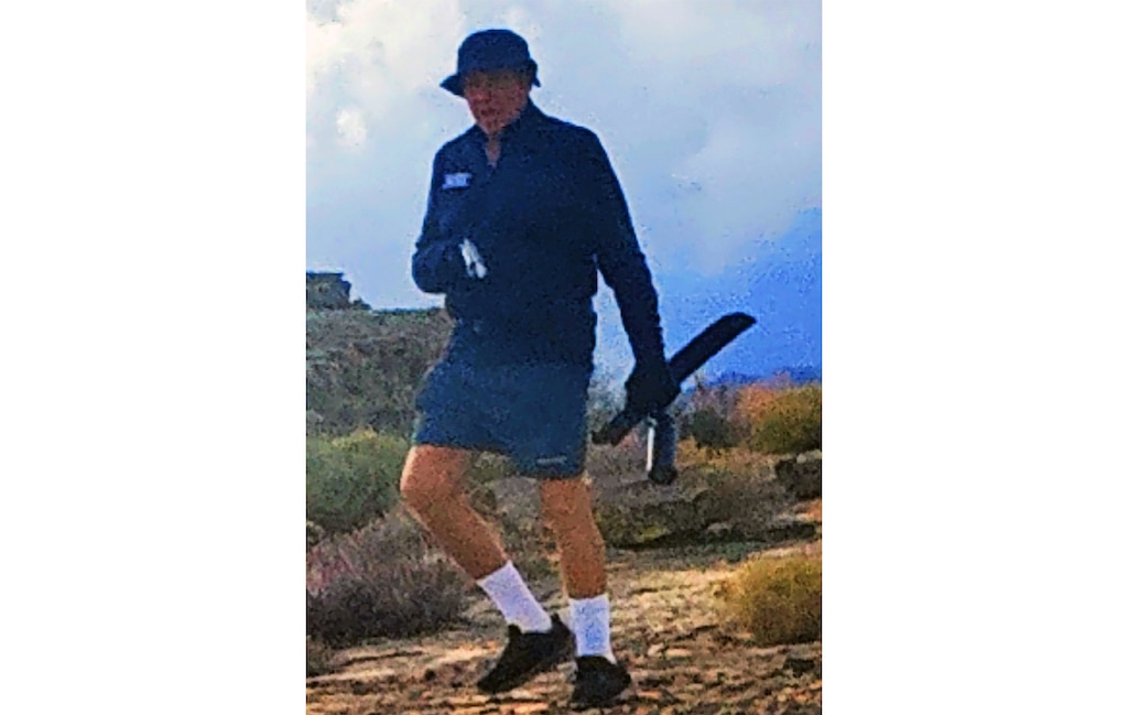 (Jaden Turner) This cell phone photograph shows an unidentified man brandishing a firearm and machete on a hike near Santa Clara, Dec. 5, 2022. Turner and others allege the man is harassing hikers with unleashed dogs.
