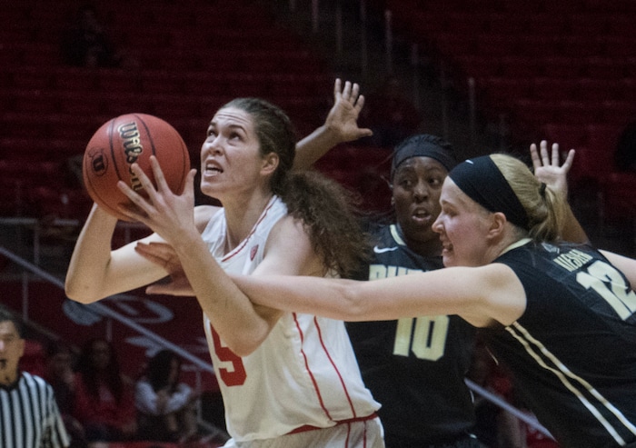 (Rick Egan  |  The Salt Lake Tribune)  Utah Utes center Megan Huff (5) is fouled by Purdue Boilermakers center Nora Kiesler (12) as she goes to the hoop, in basketball action Utah Utes vs. Purdue Boilermakers, at the Jon M. Huntsman Center, Monday, November 20, 2017.