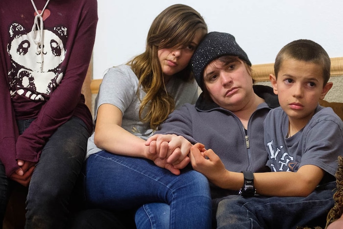 (Trent Nelson | The Salt Lake Tribune)
Alicia Rohbock, center, holds her children Rachel and Joshua tight while a family member recounts their experience in the 2008 raid on the YFZ Ranch. Rohbock was photographed in Hildale, Friday March 16, 2018.