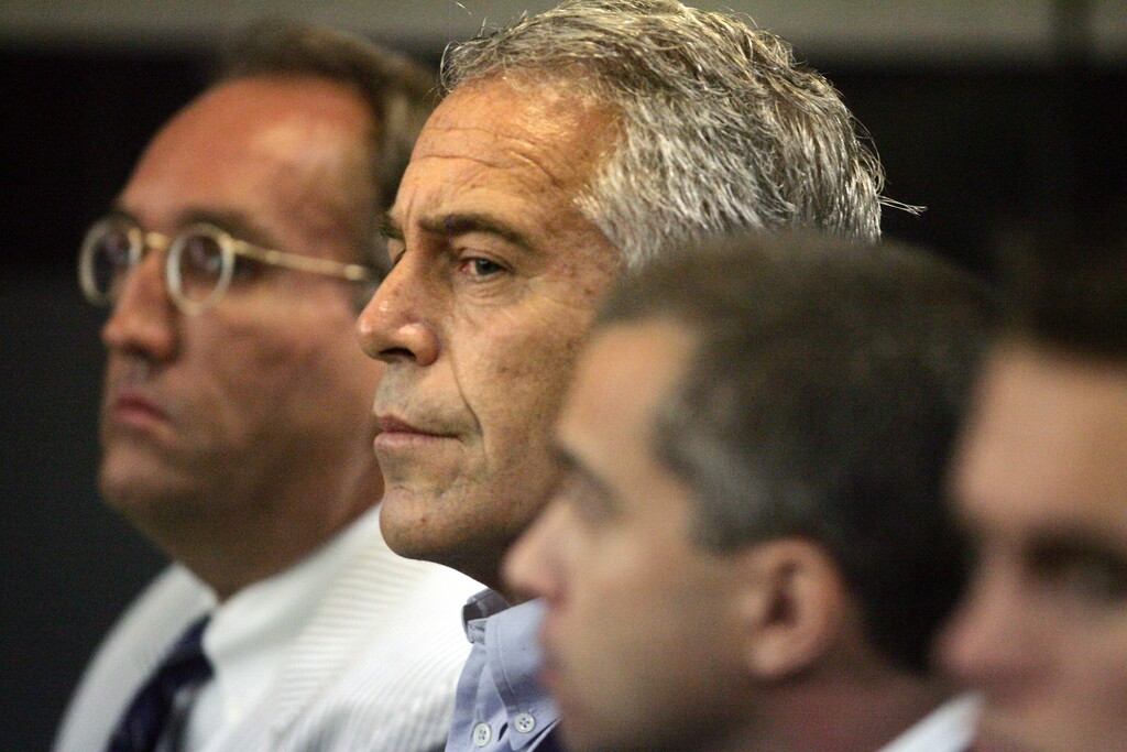 (Uma Sanghvi | Palm Beach Post | AP) In this July 30, 2008 file photo, Jeffrey Epstein, center, is shown in custody in West Palm Beach, Fla. The wealthy financier and convicted sex offender has been arrested in New York on sex trafficking charges. Two law enforcement officials said Epstein was taken into federal custody Saturday, July 6, 2019, on charges involving sex-trafficking allegations that date to the 2000s.