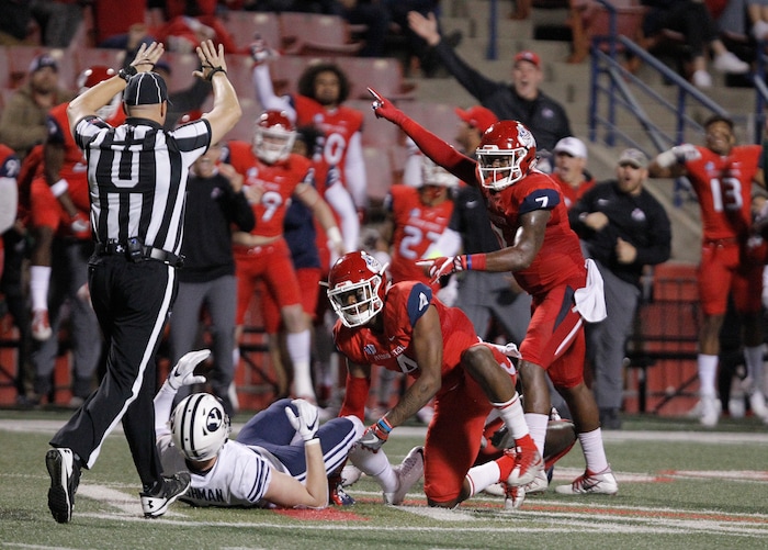 Fresno State's Mike Bell, center, and James Bailey, right, celebrate an a game clinching interception against BYU's Matt Bushman during the second half of an NCAA college football game in Fresno, Calif., Saturday, Nov. 4, 2017. Fresno State won the game 20-13. (AP Photo/Gary Kazanjian)